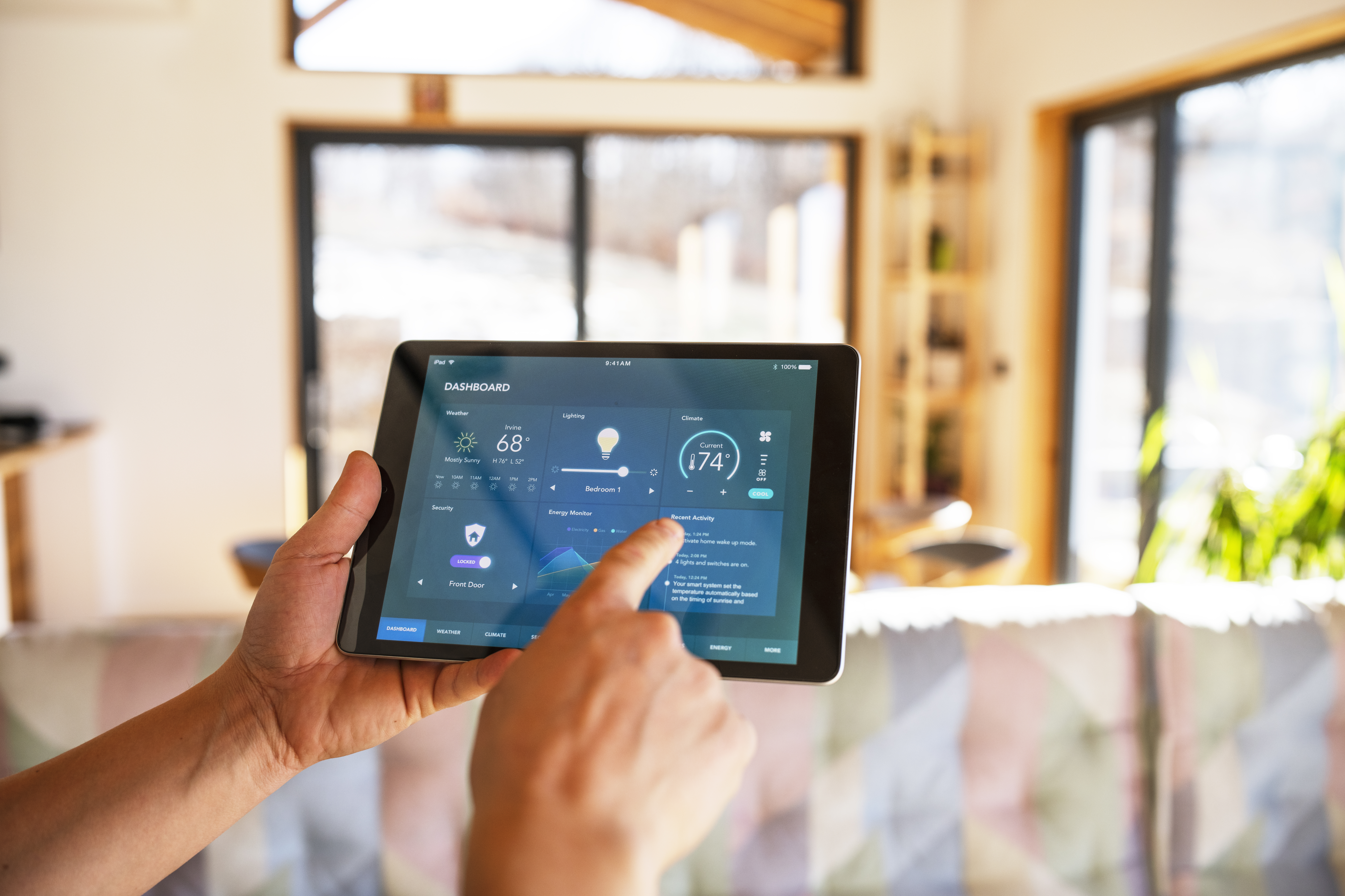 Unrecognisable man using tablet with smart home control functions at home.